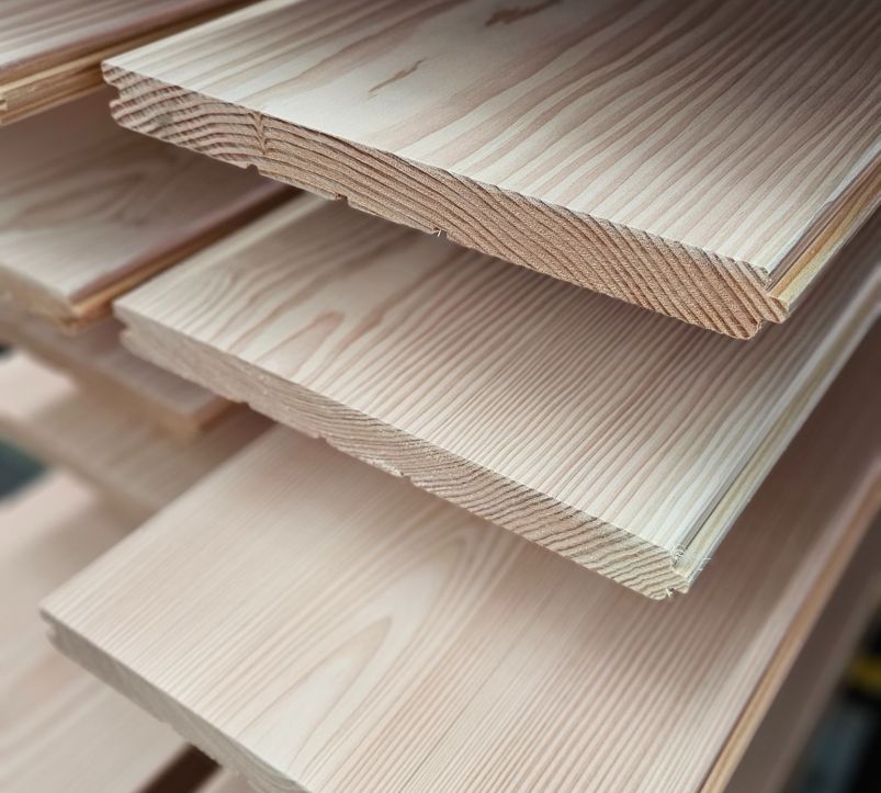 Several smooth plank floors stacked on top of each other with visible grain and beveled edges.