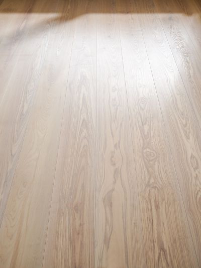 Ash wood floor with visible grain and light reflections