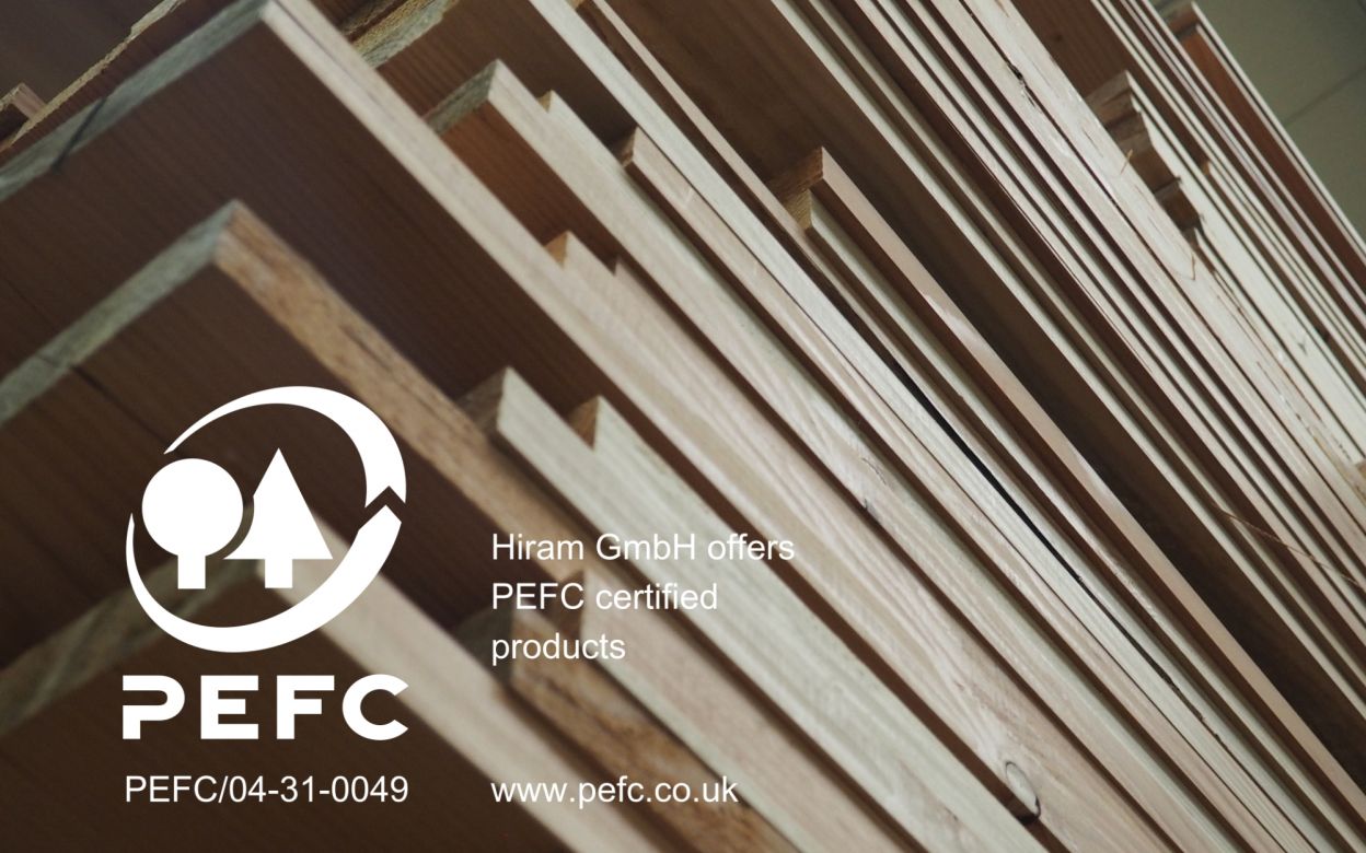 A stack of wood with a white PEFC logo visible on it.